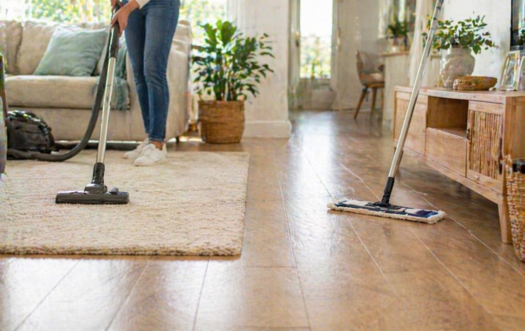 Carpet vacuuming and hard floor cleaning in a modern home representing cleaning services in Mandurah.